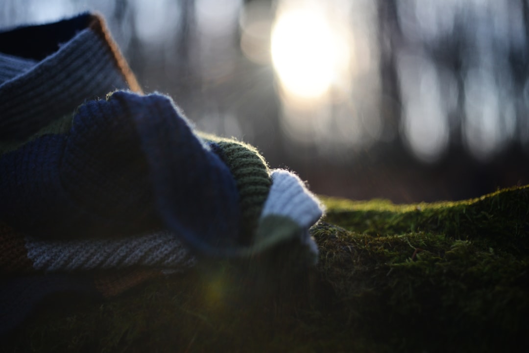 A close up of a pair of shoes on a moss covered ground