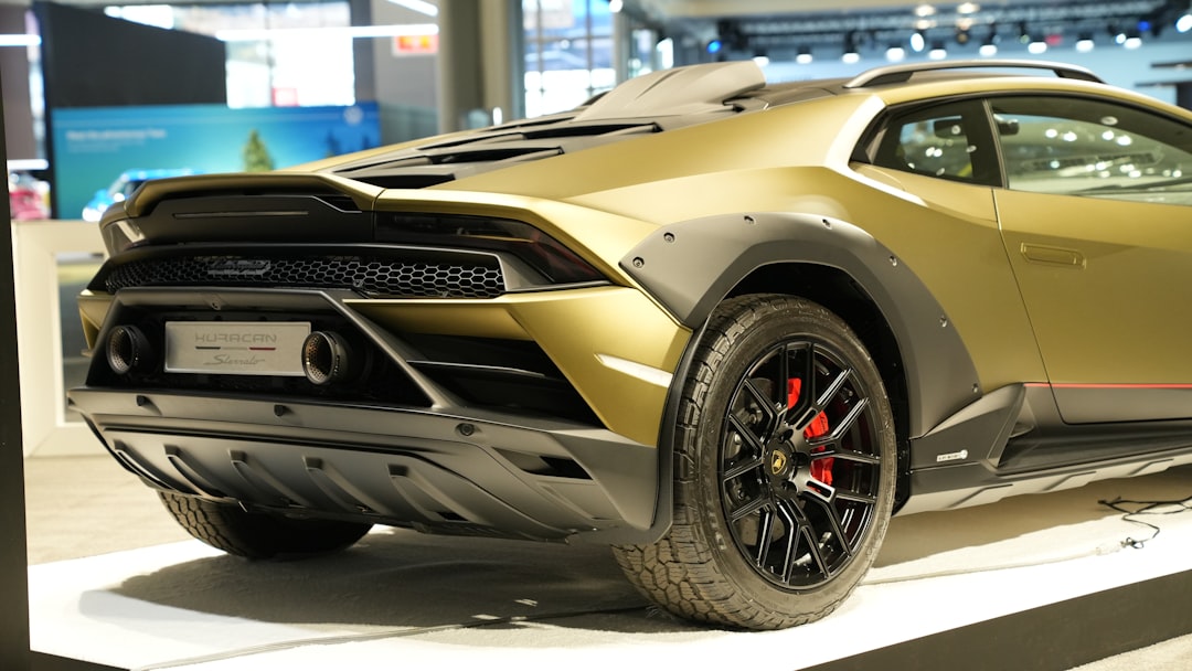 a gold colored sports car on display at a car show