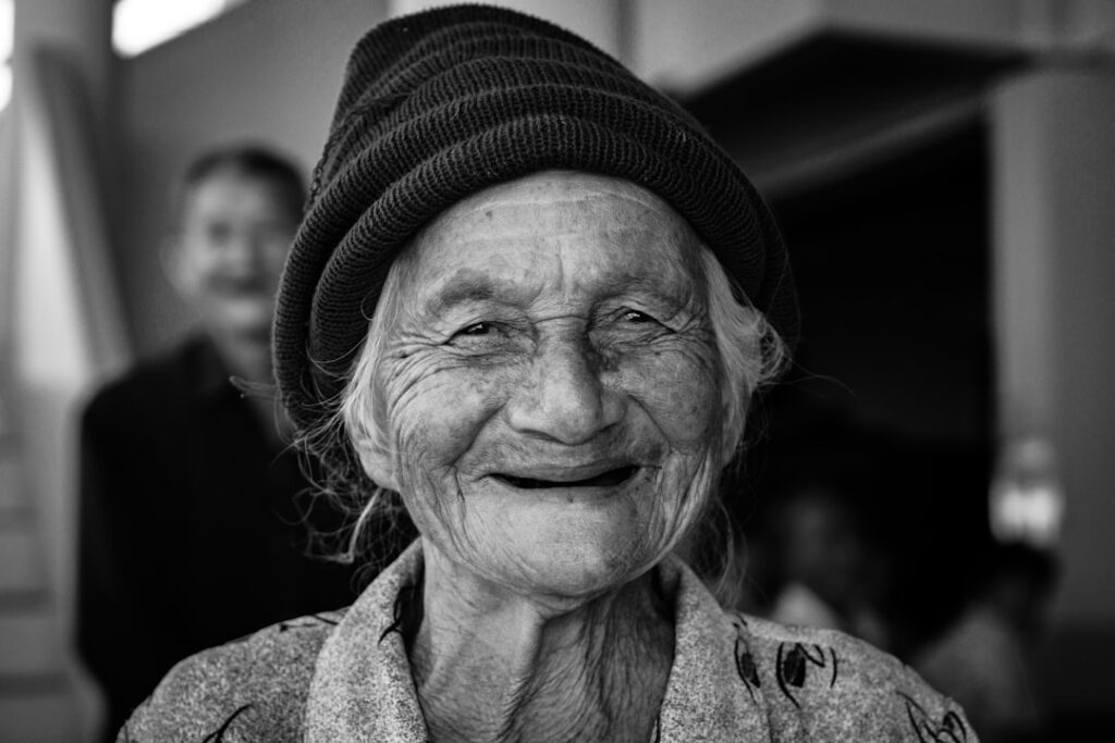 gray-scale photo of woman wearing knit cap