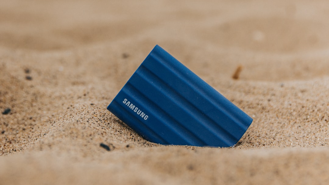 a blue plastic container on a sandy surface