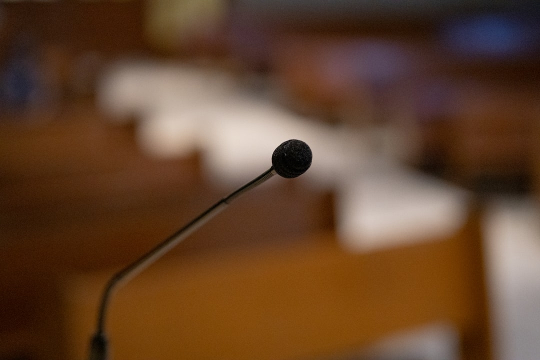 black microphone on brown wooden table