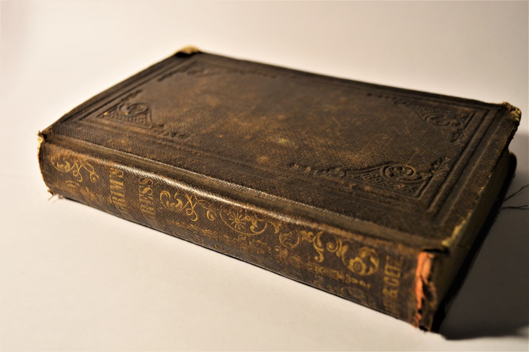 an old book sitting on top of a white table