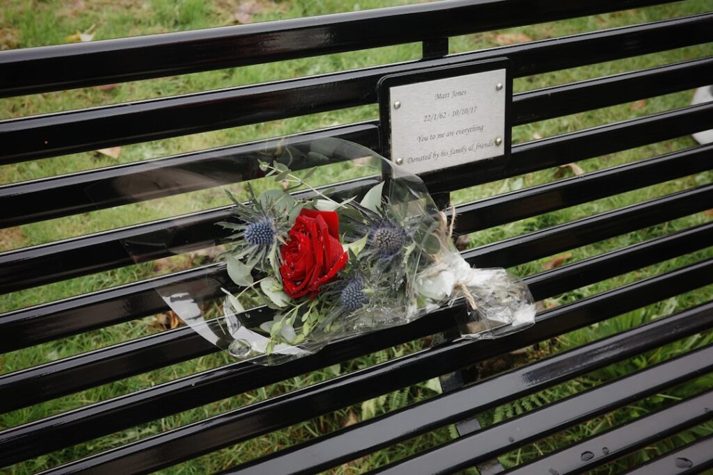 A memorial is placed on a park bench