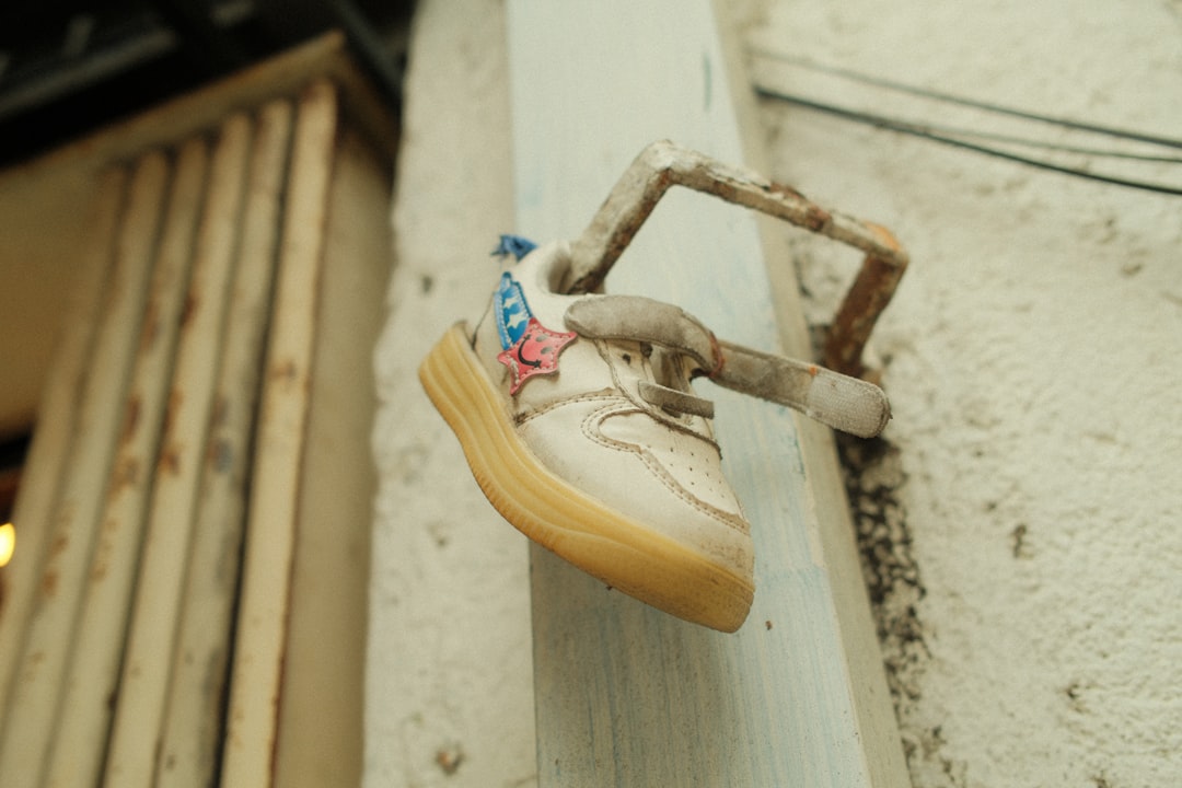A pair of shoes hanging on the side of a building