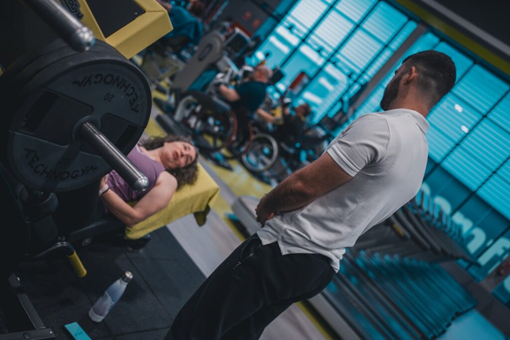 A man and a woman working out in a gym