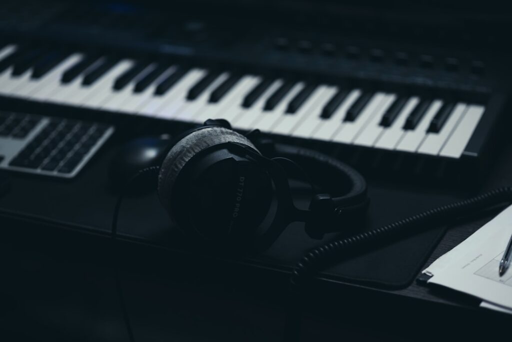 A keyboard with headphones and a microphone