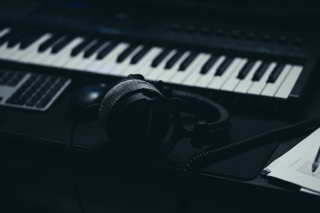 A keyboard with headphones and a microphone