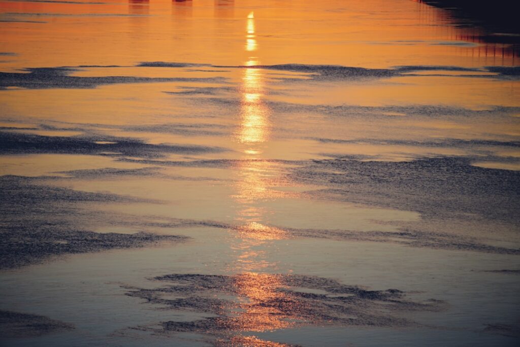 The sun is setting over a body of water